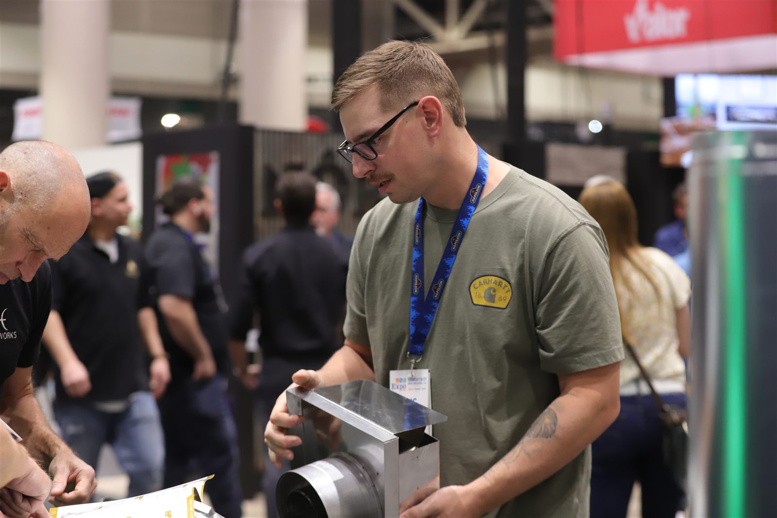 Exhibitor demonstrating a product to attendees