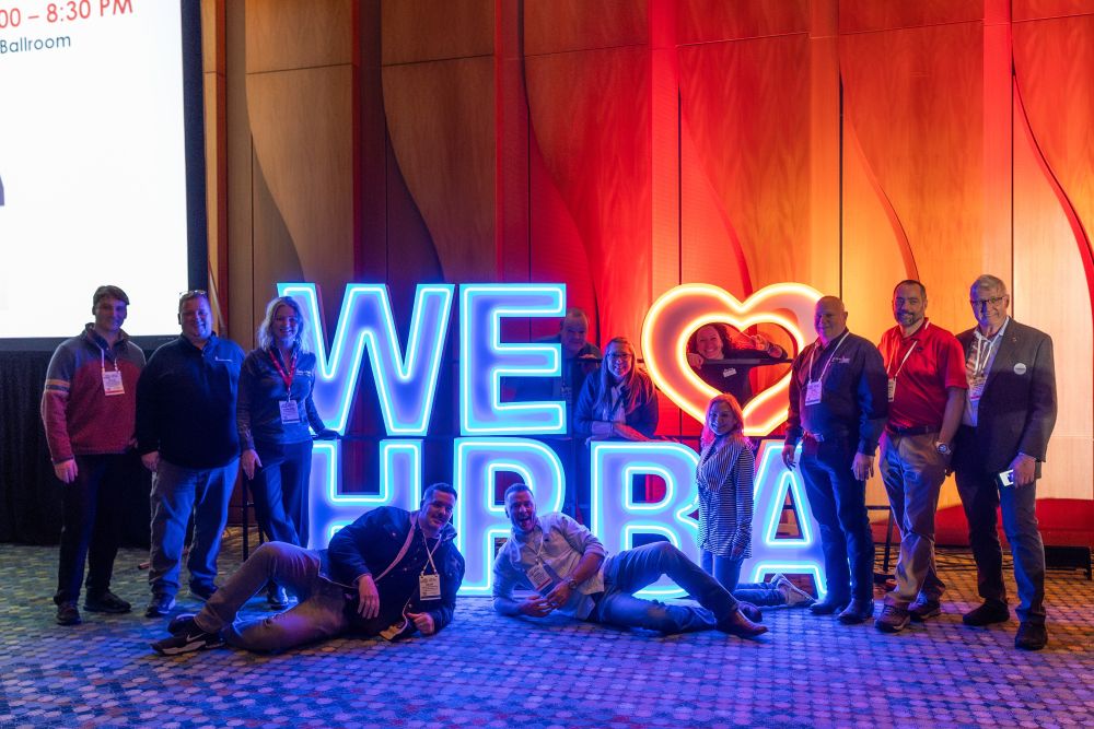 Attendees with a We Love HPBA sign at HPBExpo