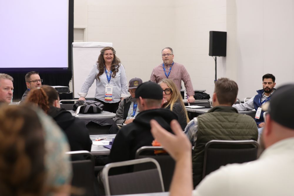 Retailers seated around tables during a Retailer Roundtable session